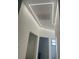 Hallway with modern LED lighting, white walls, and open doorways leading to other rooms at 2141 Cork Oak St, Sarasota, FL 34232