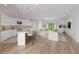 Bright open-concept living room and kitchen area with hardwood floors and modern decor at 2141 Cork Oak St, Sarasota, FL 34232