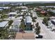 Aerial view of gray two-story home featuring a backyard pool and deck area at 220 36Th St, Holmes Beach, FL 34217
