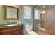 Charming bathroom features an ornate mirror, marble countertop, and glass-enclosed shower for a luxurious feel at 220 36Th St, Holmes Beach, FL 34217