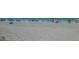 Beach scene featuring white sand, clear turquoise water, and beachgoers with umbrellas and chairs at 220 36Th St, Holmes Beach, FL 34217