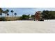 Open sandy beach scene with a lifeguard tower and dining area nearby at 220 36Th St, Holmes Beach, FL 34217
