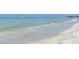 Gorgeous beach view with white sand and crystal-clear water, perfect for swimming and relaxing at 220 36Th St, Holmes Beach, FL 34217