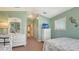 This guest bedroom features calm wall color, white furniture, and a full view of the hallway at 220 36Th St, Holmes Beach, FL 34217