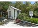 Charming historic cottage surrounded by lush greenery, offering a glimpse into the area's rich heritage at 220 36Th St, Holmes Beach, FL 34217