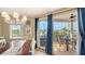 Light-filled dining area leads to a screened-in porch with outdoor seating, perfect for entertaining at 220 36Th St, Holmes Beach, FL 34217