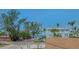 Street view showing neighboring houses and the beach in the distance at 220 36Th St, Holmes Beach, FL 34217