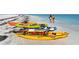 Colorful kayaks lined up on a sandy beach, perfect for exploring the serene waters of the Gulf Coast at 220 36Th St, Holmes Beach, FL 34217