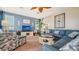 Bright living room with a large sectional sofa and tropical-themed decor accents at 220 36Th St, Holmes Beach, FL 34217