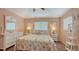 Light-filled primary bedroom features coastal decor, a queen-sized bed, and a bright window at 220 36Th St, Holmes Beach, FL 34217