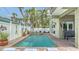 Charming backyard pool and spa area with brick-paved surround and tropical landscaping at 220 36Th St, Holmes Beach, FL 34217