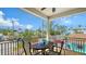 Relaxing screened porch with outdoor dining set and neighborhood views beyond at 220 36Th St, Holmes Beach, FL 34217