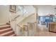 Staircase showcasing natural lighting and a view of the blue living room at 220 36Th St, Holmes Beach, FL 34217