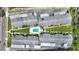 Aerial view of a condo complex with a community pool, green space, and ample parking at 2507 Beneva Rd # 2, Sarasota, FL 34232