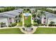 Aerial view of condominiums with well-kept grounds, community pool, landscaping and central flagpole at 2507 Beneva Rd # 2, Sarasota, FL 34232