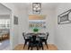 Dining area is visible from the living room and has large window and industrial style light fixture at 2507 Beneva Rd # 2, Sarasota, FL 34232