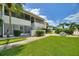 Charming condo exterior showcasing well-maintained lawn and lush landscaping on a bright sunny day at 2507 Beneva Rd # 2, Sarasota, FL 34232