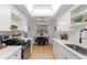 Well-lit kitchen features stainless steel appliances, white cabinets, and tiled floors at 2507 Beneva Rd # 2, Sarasota, FL 34232