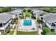 Aerial view of a community pool with lounge chairs in a manicured lawn and garden area at 2507 Beneva Rd # 2, Sarasota, FL 34232
