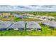 This aerial view shows the neighborhood with lush green lawns and screened-in lanais that offer a relaxing outdoor space at 251 Okeeffe Cir, Bradenton, FL 34212