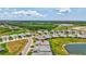 Aerial view of a well-maintained property with landscaped grounds, pond, and the home's overall setting within a Primary-planned community at 251 Okeeffe Cir, Bradenton, FL 34212
