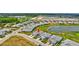 Aerial view of a modern home with a gray tile roof in a community with ponds and green spaces, showcasing the property's location at 251 Okeeffe Cir, Bradenton, FL 34212