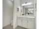 Clean and well-lit bathroom featuring a single vanity, quartz countertop, tile flooring, and a toilet at 251 Okeeffe Cir, Bradenton, FL 34212
