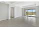 Spacious bedroom with tile floors, tray ceiling, and access to the lanai via sliding glass doors at 251 Okeeffe Cir, Bradenton, FL 34212