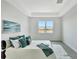 Cozy bedroom with a large window, tray ceiling, neutral decor, and a view of the community at 251 Okeeffe Cir, Bradenton, FL 34212