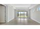Spacious bedroom featuring sliding glass doors with view of backyard, tile floors, and light walls at 251 Okeeffe Cir, Bradenton, FL 34212