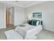 Comfortable bedroom featuring neutral colors, plush bedding, and tile floors, creating a relaxing atmosphere at 251 Okeeffe Cir, Bradenton, FL 34212