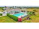 Community pool area with chairs, outdoor grilling area, and manicured landscaping at 251 Okeeffe Cir, Bradenton, FL 34212
