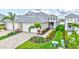 Lushly landscaped home exterior with manicured lawn, beautiful plants and palm trees at 251 Okeeffe Cir, Bradenton, FL 34212