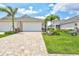 Gorgeous exterior view of a home boasting a large driveway and lush, tropical landscaping at 251 Okeeffe Cir, Bradenton, FL 34212
