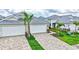 Landscaped view of home featuring paver driveway, manicured lawn, and tidy landscaping at 251 Okeeffe Cir, Bradenton, FL 34212