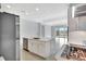View of kitchen island and stainless steel appliances with view of the living room and outdoor patio at 251 Okeeffe Cir, Bradenton, FL 34212