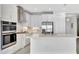 Bright white kitchen featuring stainless steel appliances, a large island, and ample cabinet space at 251 Okeeffe Cir, Bradenton, FL 34212