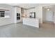Modern kitchen with white cabinets, stainless steel appliances, and adjacent living space at 251 Okeeffe Cir, Bradenton, FL 34212