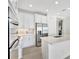 Bright and modern kitchen with white cabinets, stainless steel fridge, and center island with sink at 251 Okeeffe Cir, Bradenton, FL 34212