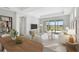 Bright living room featuring modern furniture, stylish decor, and sliding glass doors to the outdoor space at 251 Okeeffe Cir, Bradenton, FL 34212