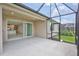 Screened-in lanai with a view of the well manicured yard. Sliding door entry to the home at 251 Okeeffe Cir, Bradenton, FL 34212