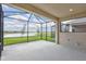 Screened in lanai with views of the pond and lush landscaping in the backyard at 251 Okeeffe Cir, Bradenton, FL 34212