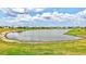 A scenic community lake is bordered by lush green spaces and perfectly maintained homes at 251 Okeeffe Cir, Bradenton, FL 34212