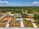 Aerial view of the house and neighborhood surrounded by lush greenery and tall trees at 2759 Starview Ave, North Port, FL 34288