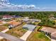 Aerial view of the house and neighborhood featuring lush trees and clear skies at 2759 Starview Ave, North Port, FL 34288