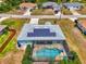 Well-maintained single-story home featuring a screened pool, solar panels, and lush landscaping at 2759 Starview Ave, North Port, FL 34288