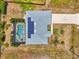 High-angle view of a house with solar panels and screen-enclosed pool at 2759 Starview Ave, North Port, FL 34288