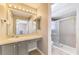 Bright bathroom featuring a vanity and tiled shower with glass door at 2759 Starview Ave, North Port, FL 34288
