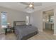 Neutral Primary bedroom with ceiling fan, side tables, and attached bathroom at 2759 Starview Ave, North Port, FL 34288