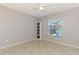 This spare bedroom features a window overlooking the screened lanai at 2759 Starview Ave, North Port, FL 34288